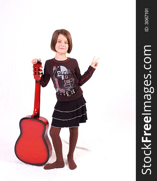 Brunette little girl and her red guitar