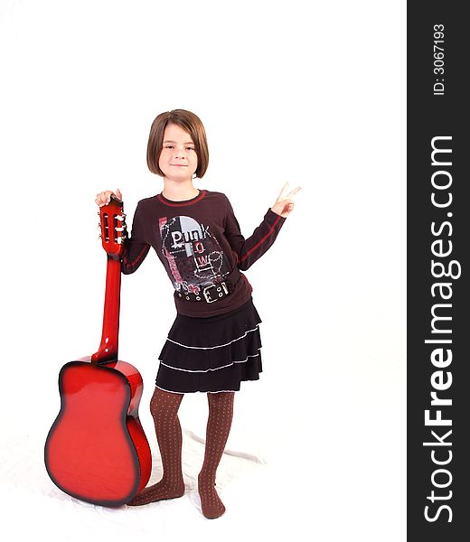 Brunette little girl and her red guitar