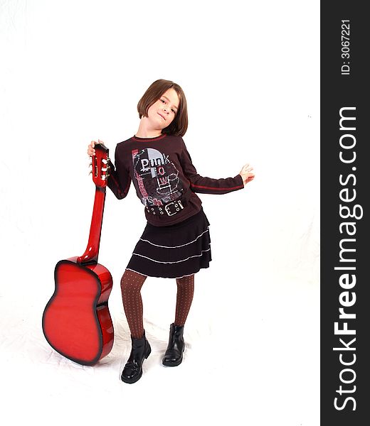 Brunette little girl and her red guitar