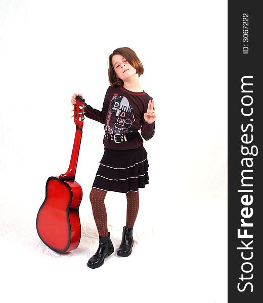 Brunette little girl and her red guitar