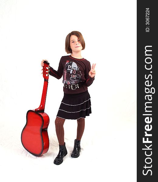 Brunette little girl and her red guitar