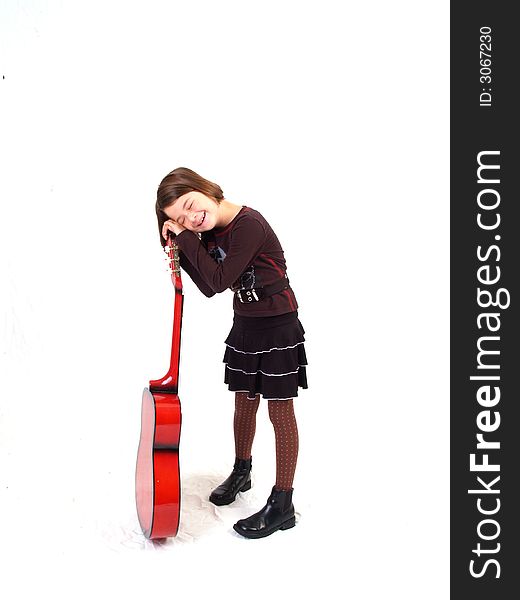 Brunette little girl and her red guitar