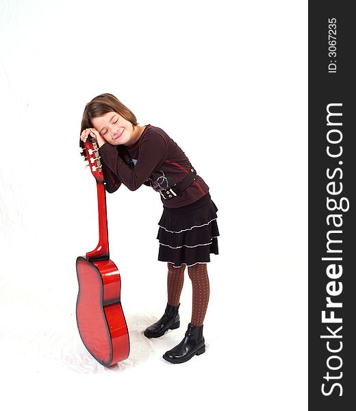 Brunette little girl and her red guitar