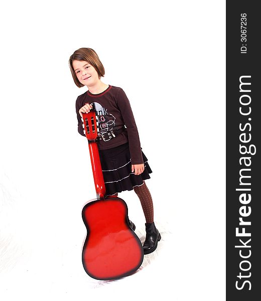 Brunette little girl and her red guitar