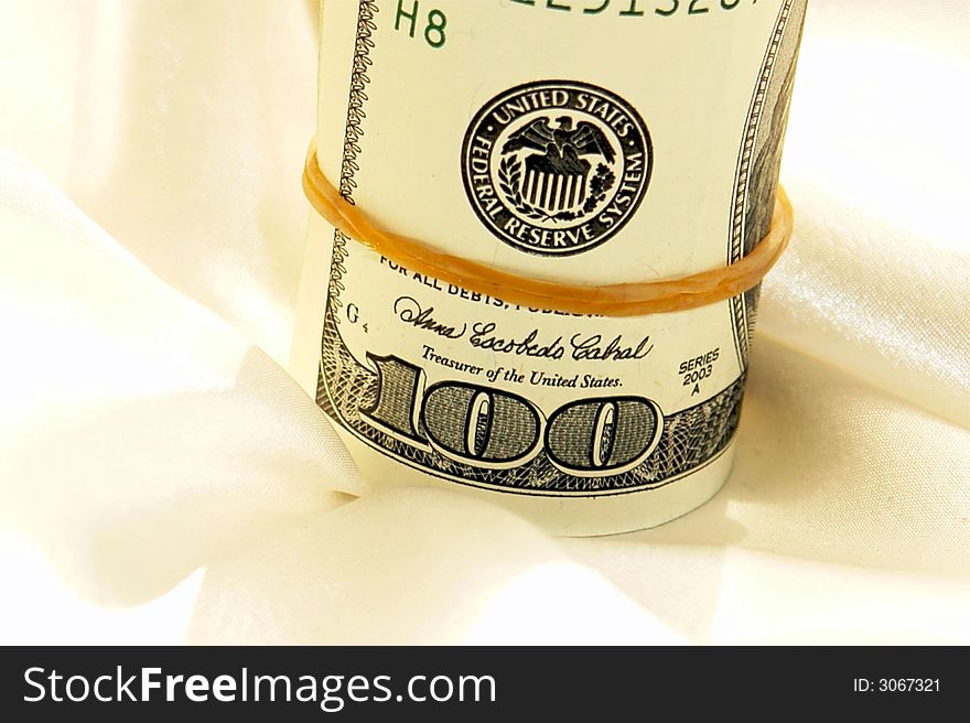 Close up of roll of hundred dollar bills with rubber band. Close up of roll of hundred dollar bills with rubber band