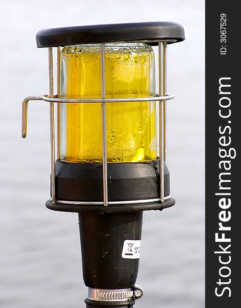 Misted over yacht yellow color lantern  overwater. Misted over yacht yellow color lantern  overwater