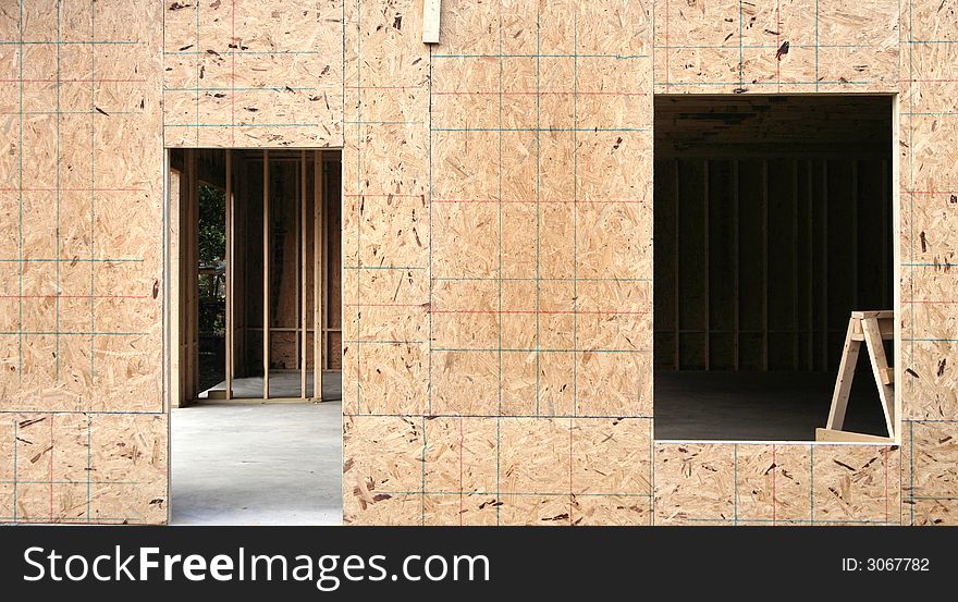 Plywood framing and cutouts for a home under construction. Plywood framing and cutouts for a home under construction.