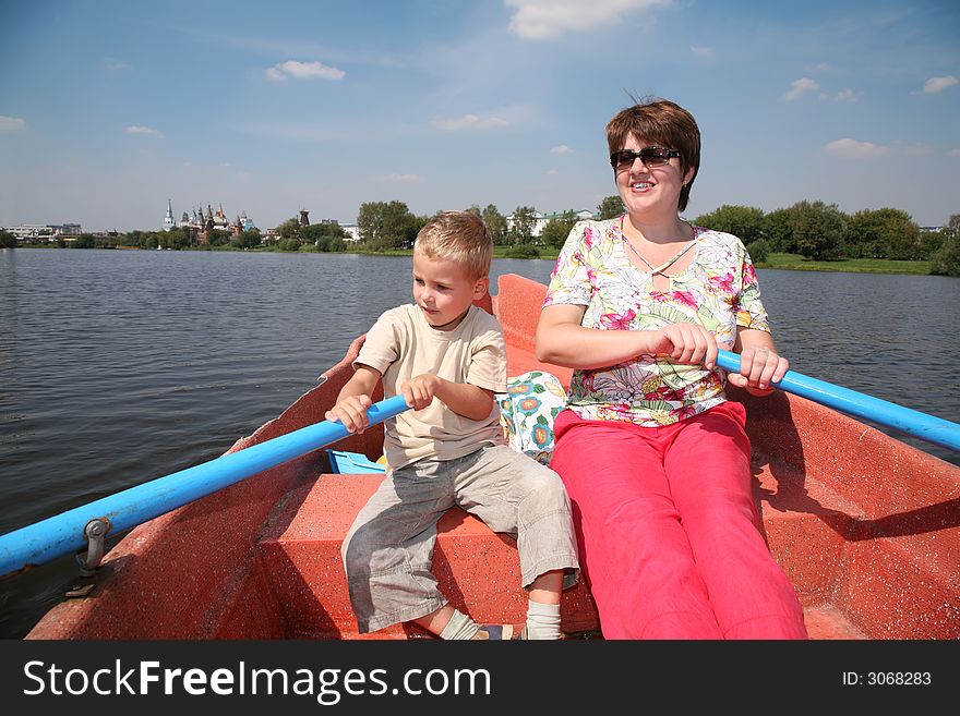 Woman and boy in the boat with the oars