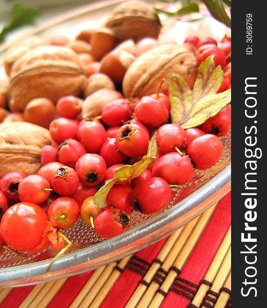 Hazelnuts, walnuts and haw assorted on the plate. Hazelnuts, walnuts and haw assorted on the plate