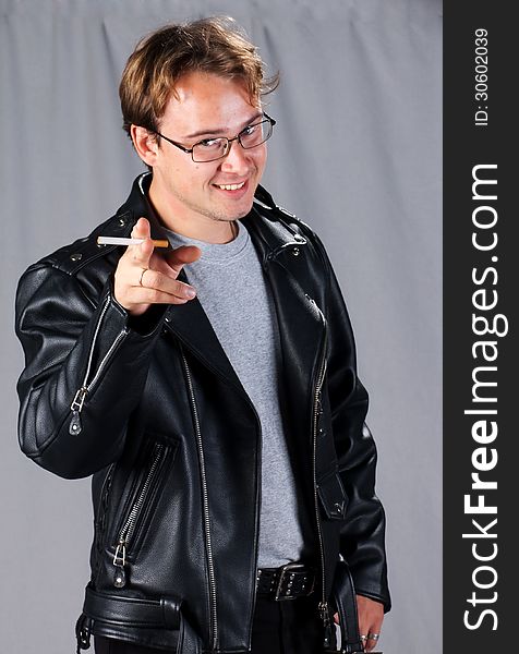 Young man in leather Jacket with cigarette