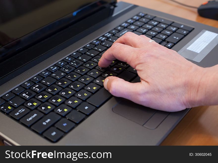 Man's hand on a black computer keyboard. Man's hand on a black computer keyboard
