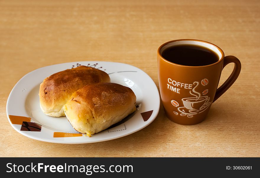 Cup of hot coffee and a plate of cakes on the table. Cup of hot coffee and a plate of cakes on the table