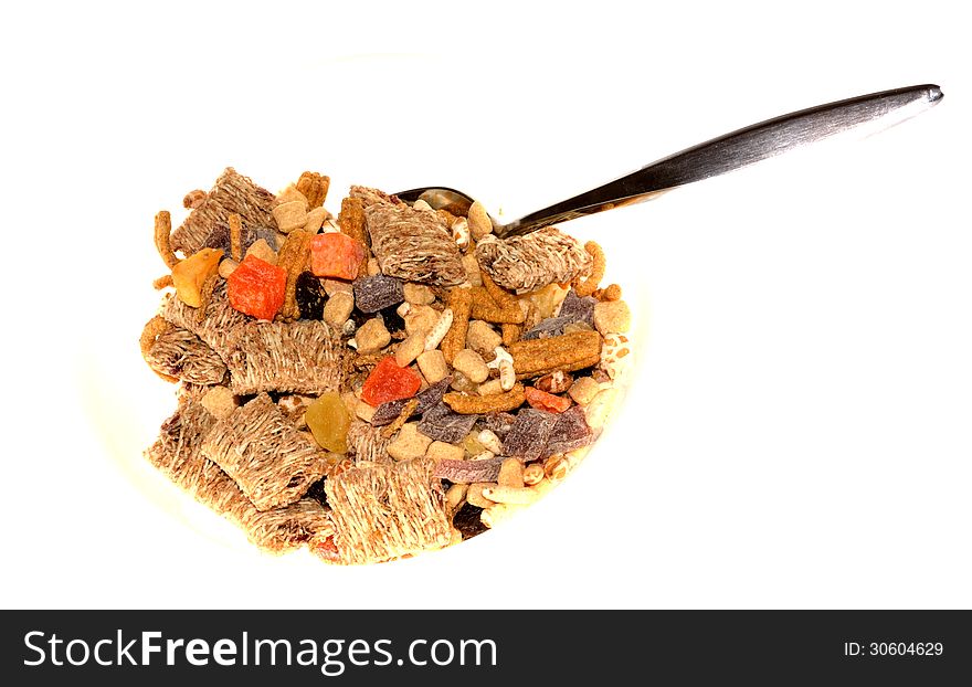 Healthy cereal with fiber and fruit bits and a spoon. Healthy cereal with fiber and fruit bits and a spoon.