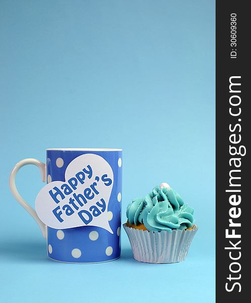 Happy Fathers Day special treat blue and white beautiful decorated cupcakes with message on blue background, with blue polka dot coffee mug. ertical with copy space for your text here. Happy Fathers Day special treat blue and white beautiful decorated cupcakes with message on blue background, with blue polka dot coffee mug. ertical with copy space for your text here.