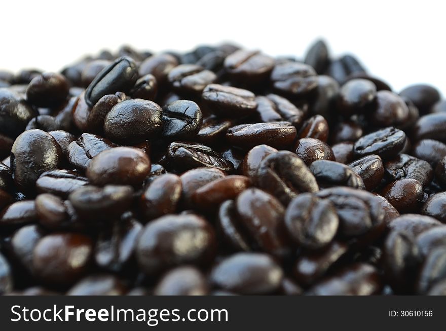 Roasted coffee beans on white background