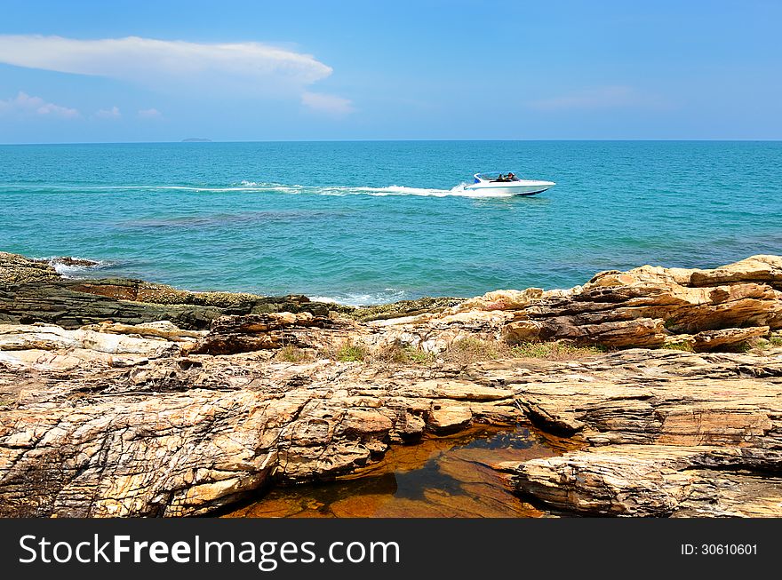 Sea with rock at day time