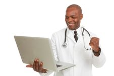 African-American Doctor With Laptop Excited Stock Photography African-American Doctor With Laptop Excited Stock Photography