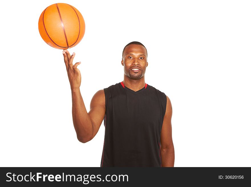 Portrait of a happy young basketball player spinning ball on finger isolated on white. waist up, horizontal shot. Portrait of a happy young basketball player spinning ball on finger isolated on white. waist up, horizontal shot.