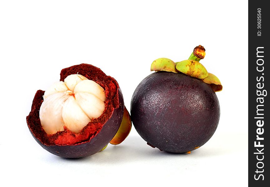 Mangosteen fruits and cross section showing the thick purple skin