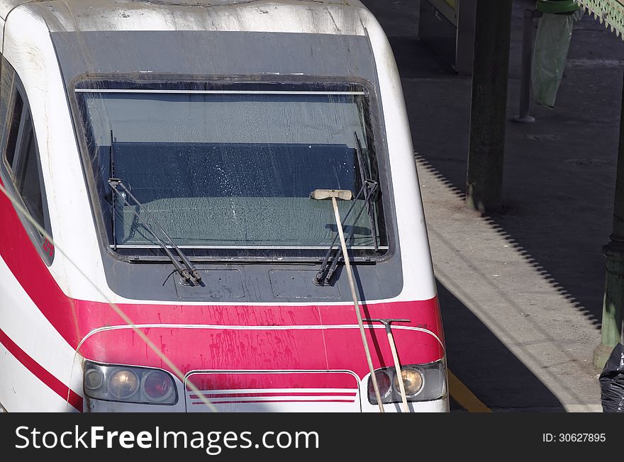 Cleaning a train in a station