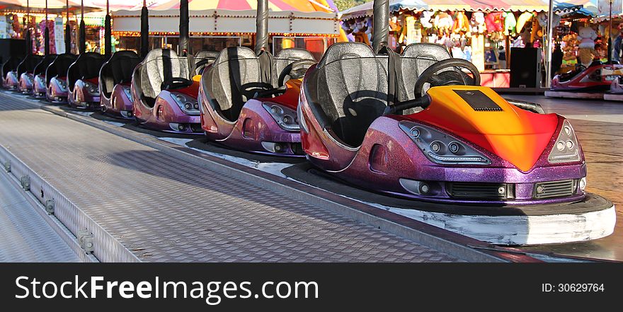 A Line of Dodgem Cars at a Fun Fair Amusement Park. A Line of Dodgem Cars at a Fun Fair Amusement Park.