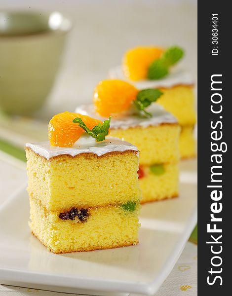 A delicious orang cake with fruit layer and toping cream. A delicious orang cake with fruit layer and toping cream