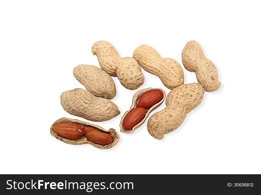 Image of groundnuts isolated on white background; two nuts are cracked open, showing reddish brown seeds. Clipping path included.