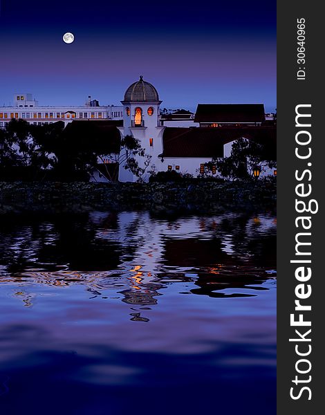 Beautiful old white building with a dome roof reflecting in calm water with full moon and evening sky. Beautiful old white building with a dome roof reflecting in calm water with full moon and evening sky.