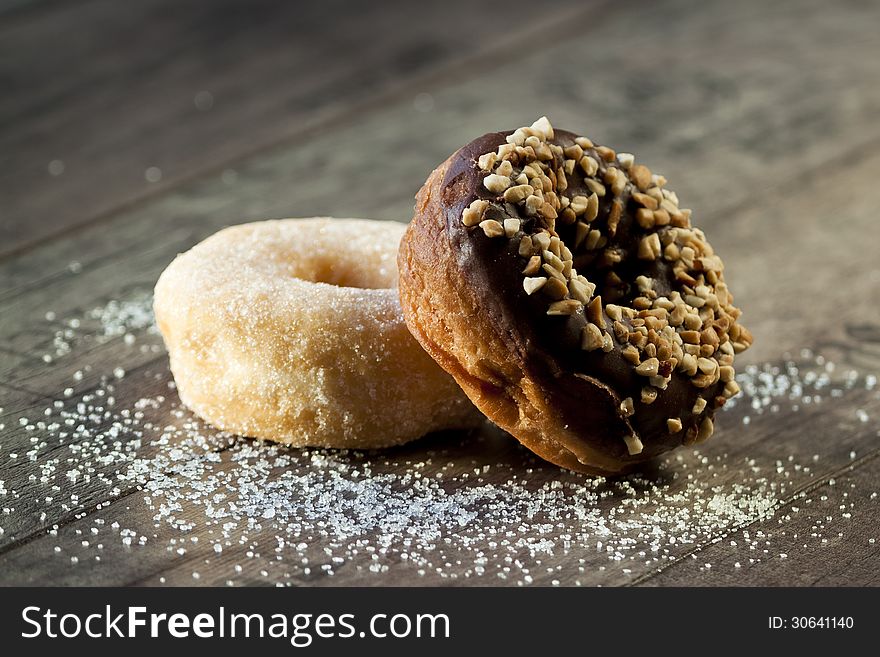 Chocolate and Sugar Donuts with sun light on the advertise Table. Chocolate and Sugar Donuts with sun light on the advertise Table