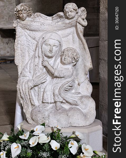 Bas-relief stone madonna with child