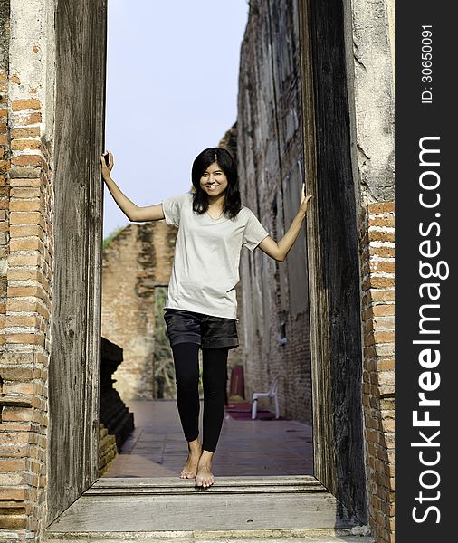 Asian woman enjoying at Buddhist temple in Thailand.