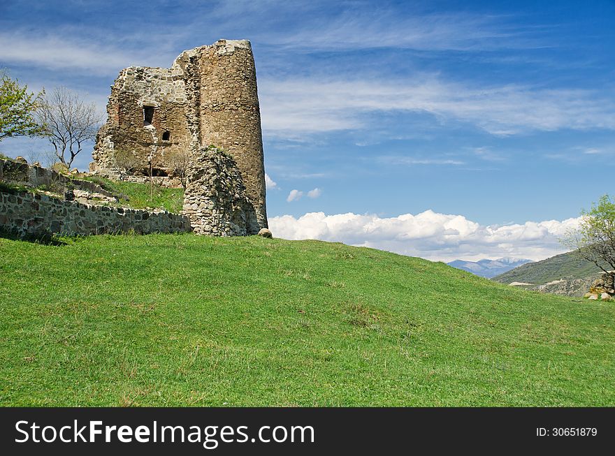 Ruin of medieval fortress sitting on grassy hill. Georgia. Ruin of medieval fortress sitting on grassy hill. Georgia