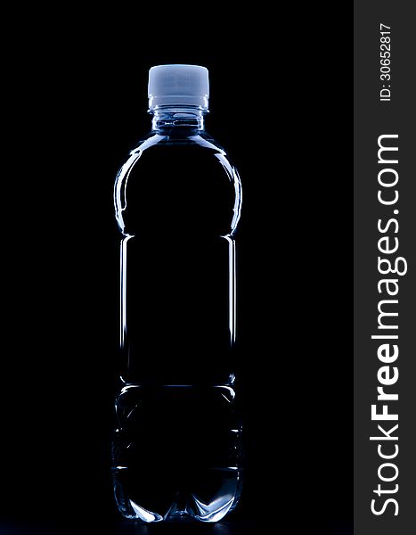 Silhouette of water bottle on black background