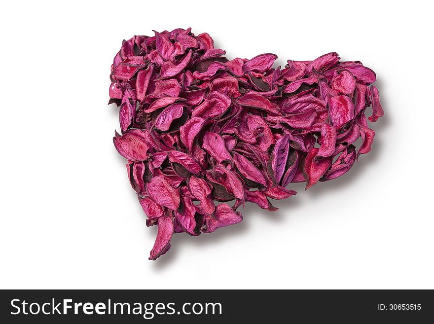 Heart shape made of dried flower petals on white background