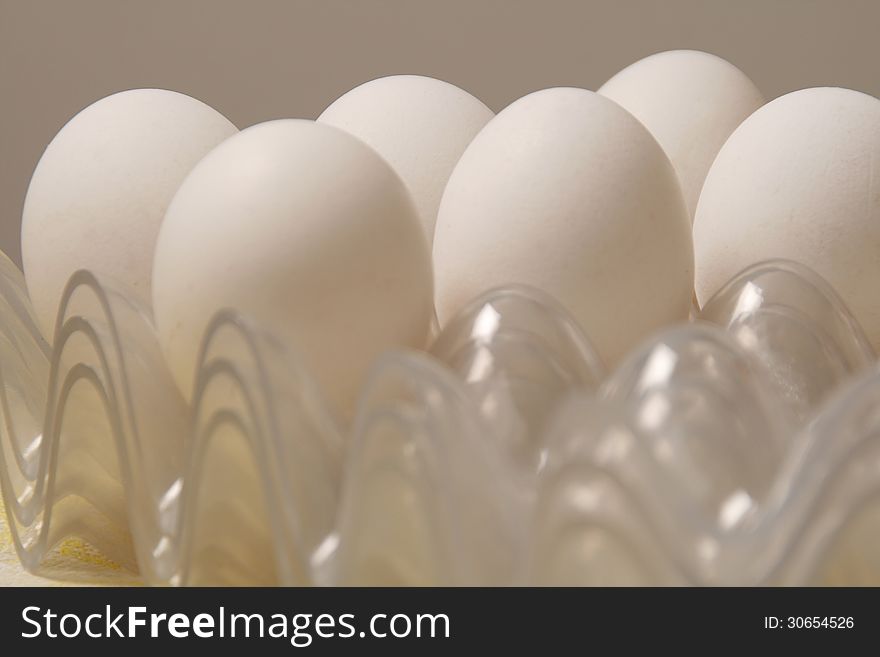 White chicken eggs in plastic package.