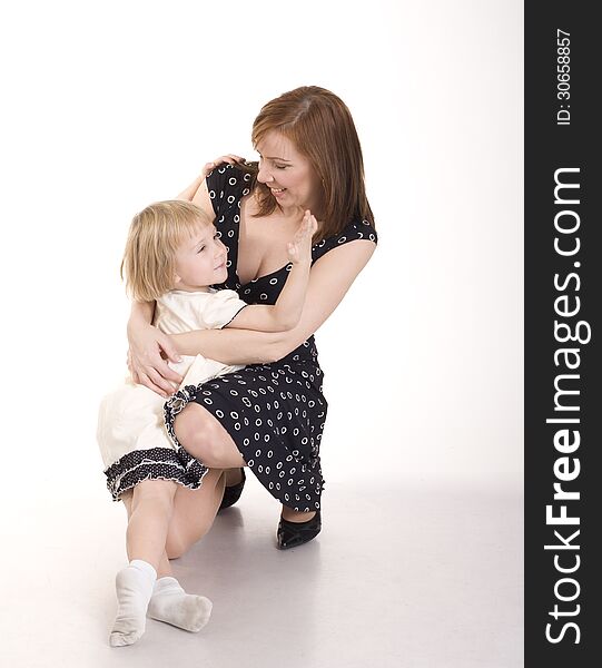 Portrait of happy mother and daughter hugging in beauty dress isolated