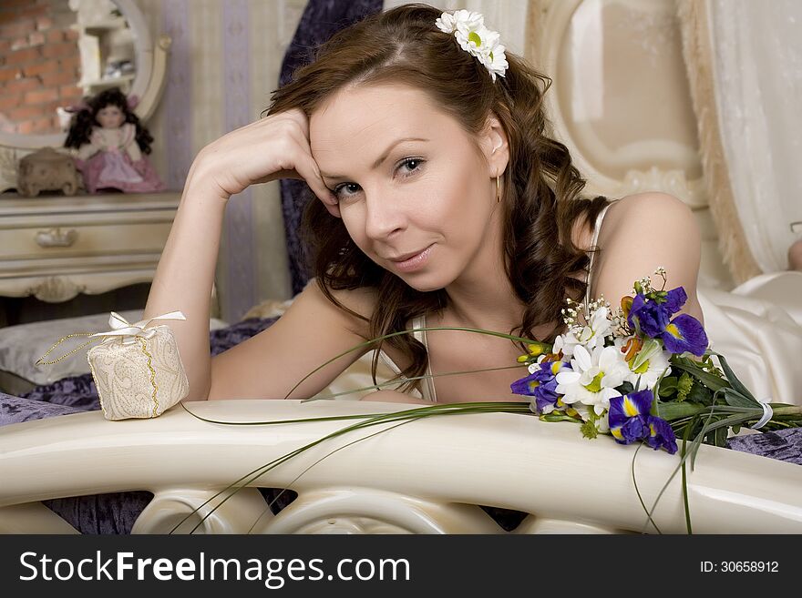 Woman With Flowers In Bed