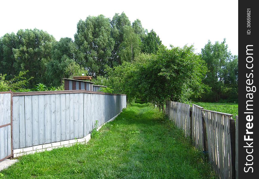 Fence And Little Street In Rural Manor