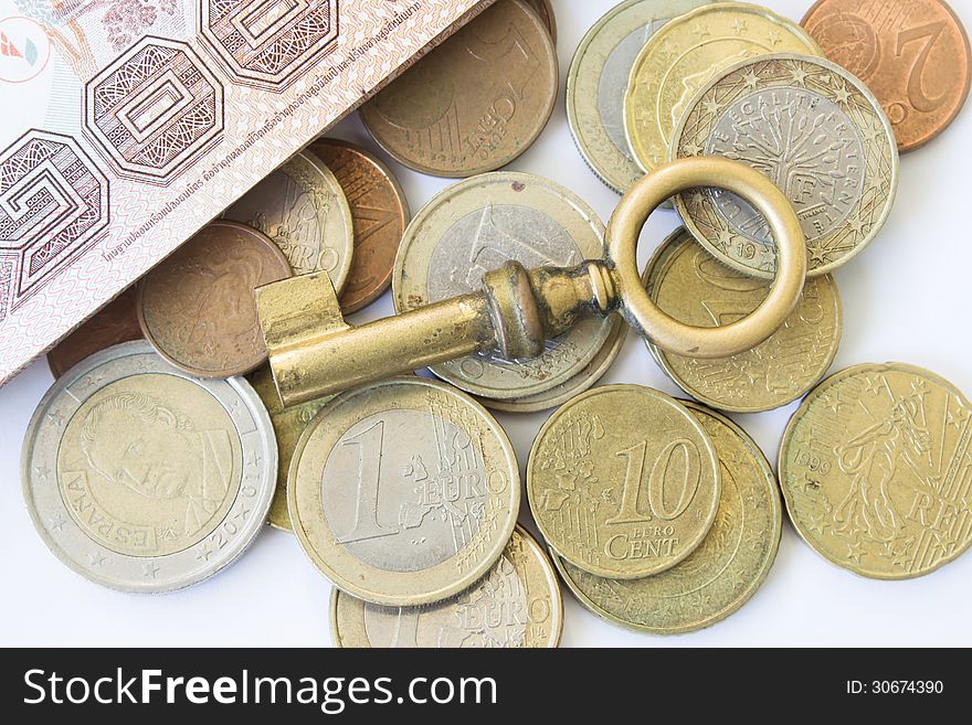 Old Key On Euro Coins Money For Financial Concept Background. Old Key On Euro Coins Money For Financial Concept Background