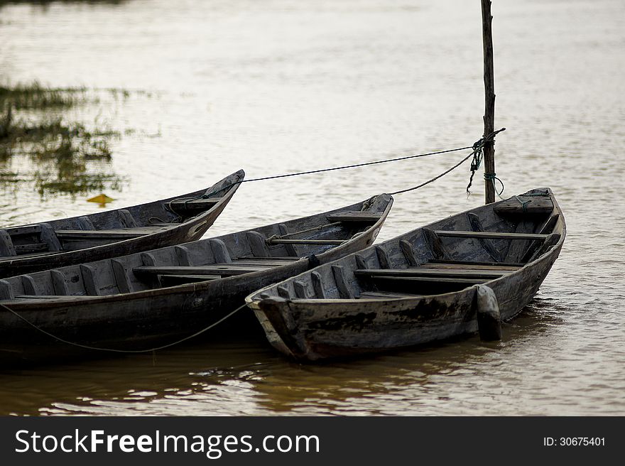 Three rowboats on the river at Hoi An, Vietnam