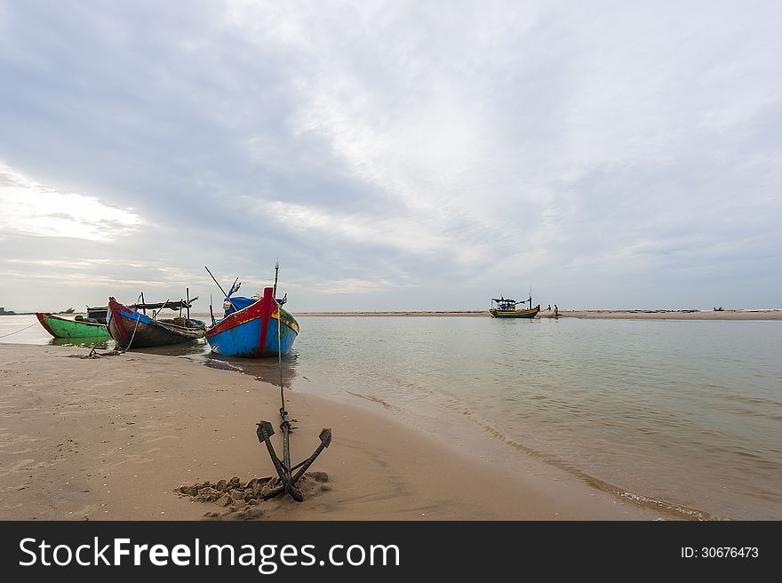Fishing boat and anchor on the beach