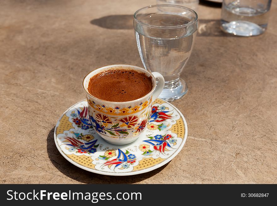 Trditionally served turkish coffee at the street cafe under light sun, Istanbul, Turkey