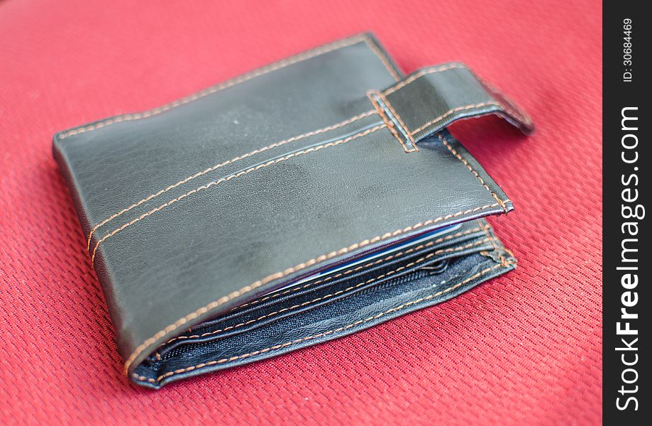 Brown wallet on red background