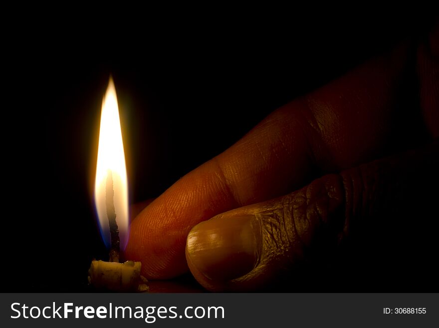 Flame of a burnt candle isolated on dark black background. Flame of a burnt candle isolated on dark black background.