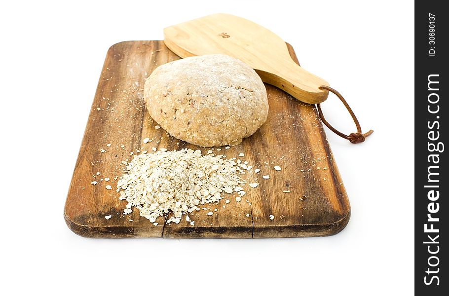 Raw ball of dough on wooden board on white background