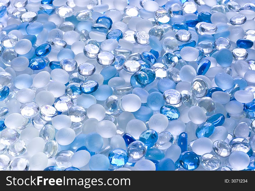 Scattering of small glass white and blue balls. Scattering of small glass white and blue balls