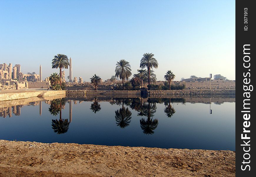 The reflection of palms and monuments, abeliscs in water