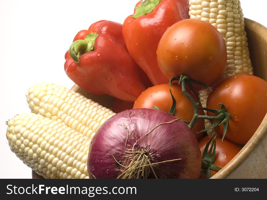 Vegetables fesh in wooden bowl corn tomatoes red peppers bermuda onion. Vegetables fesh in wooden bowl corn tomatoes red peppers bermuda onion