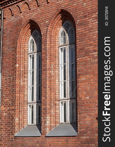 Red brick wall of church with windows. Red brick wall of church with windows