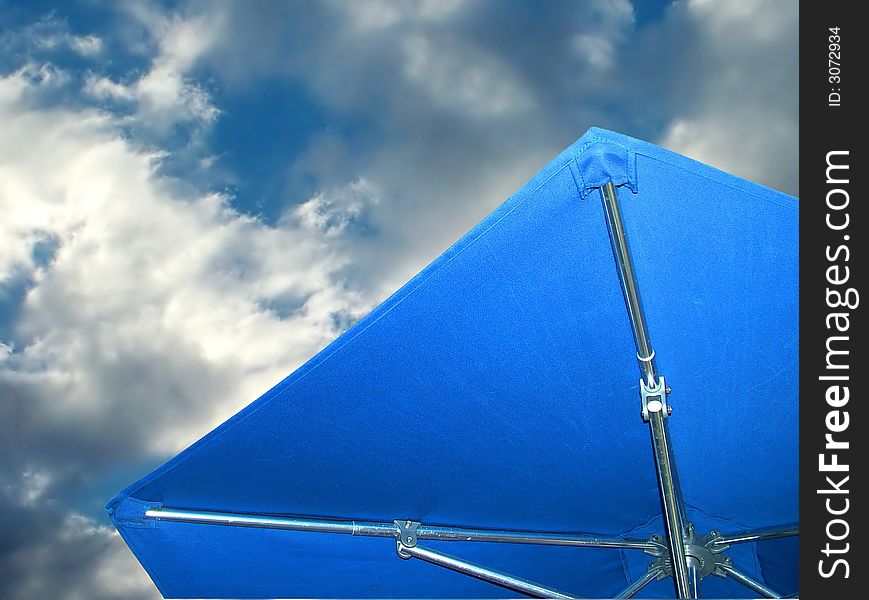 Under Blue Umbrella, storm clouds overhead. Under Blue Umbrella, storm clouds overhead